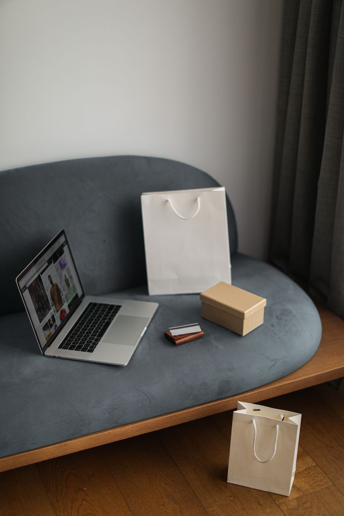services-04 Contemporary e-commerce scene with laptop, shopping bags, and a credit card, ideal for online shopping concepts.